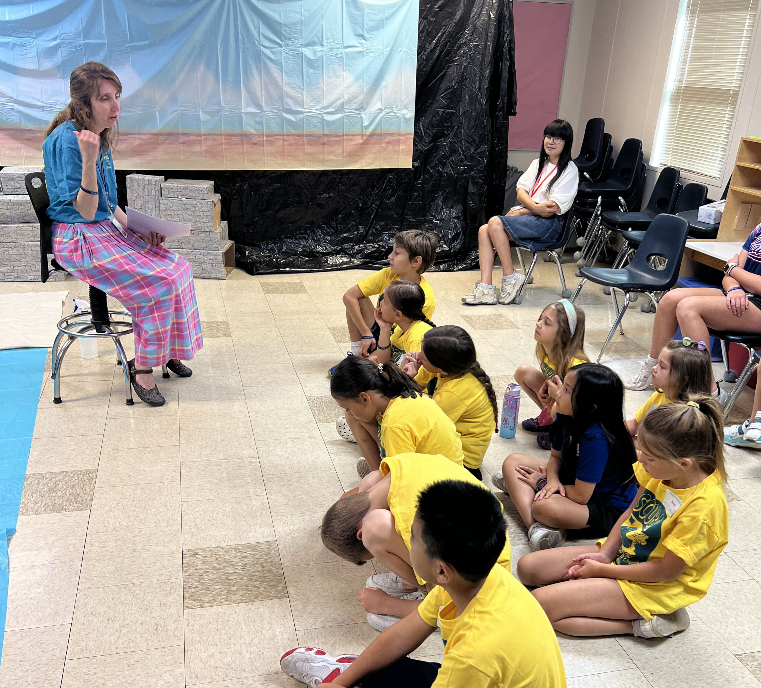 Woman speaking to group of children